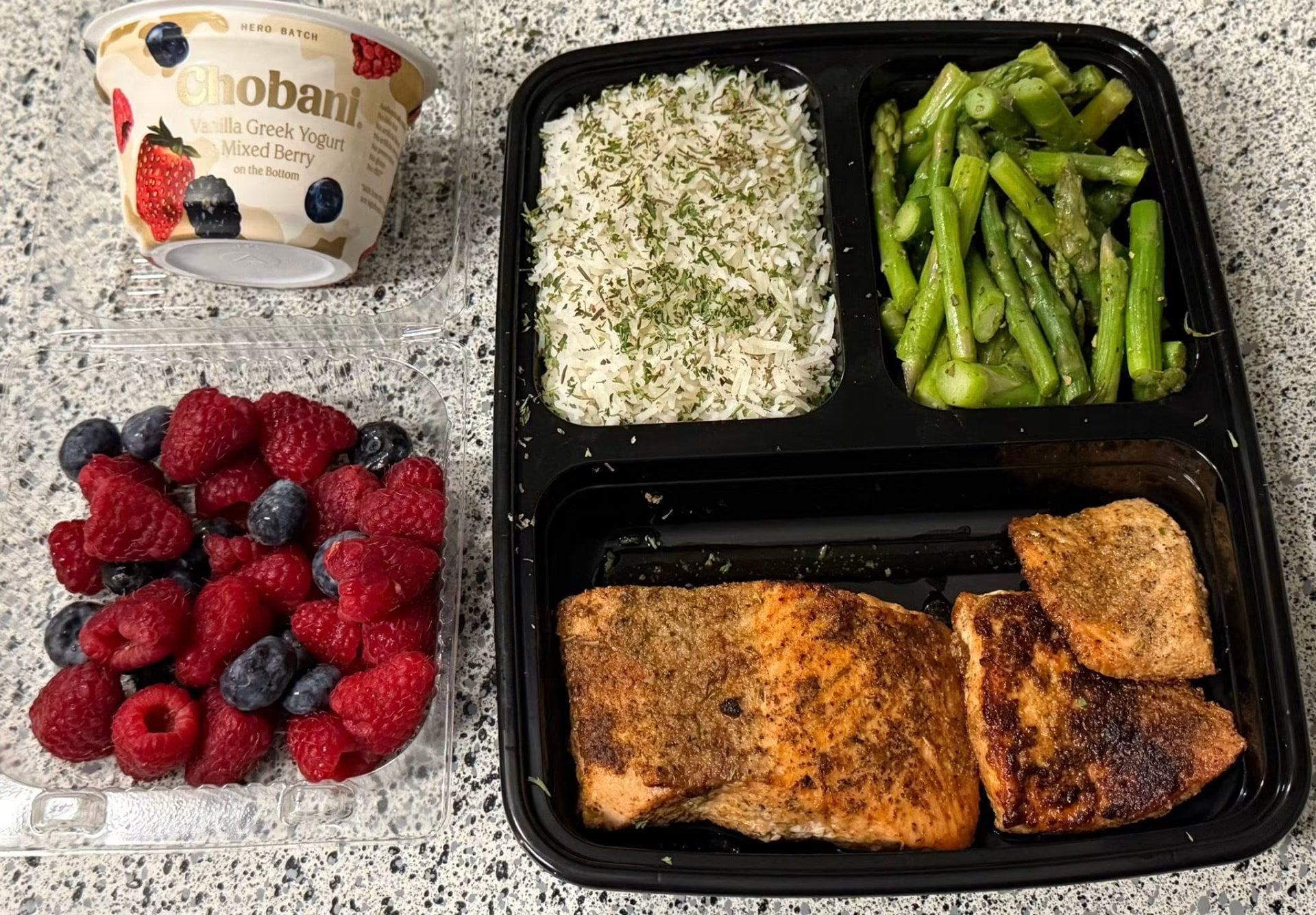 Blackened salmon with rice, asparagus, berries and yogurt