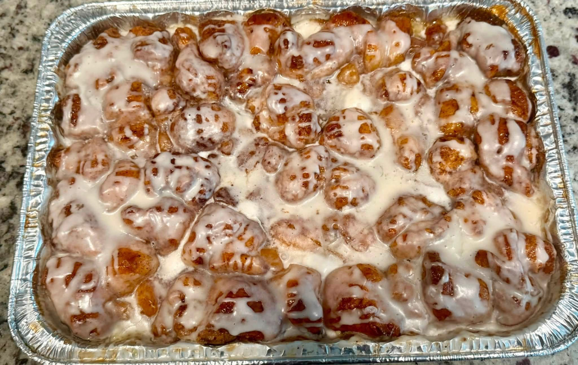 Peach cobbler monkey bread half pan drizzled with sweet glaze