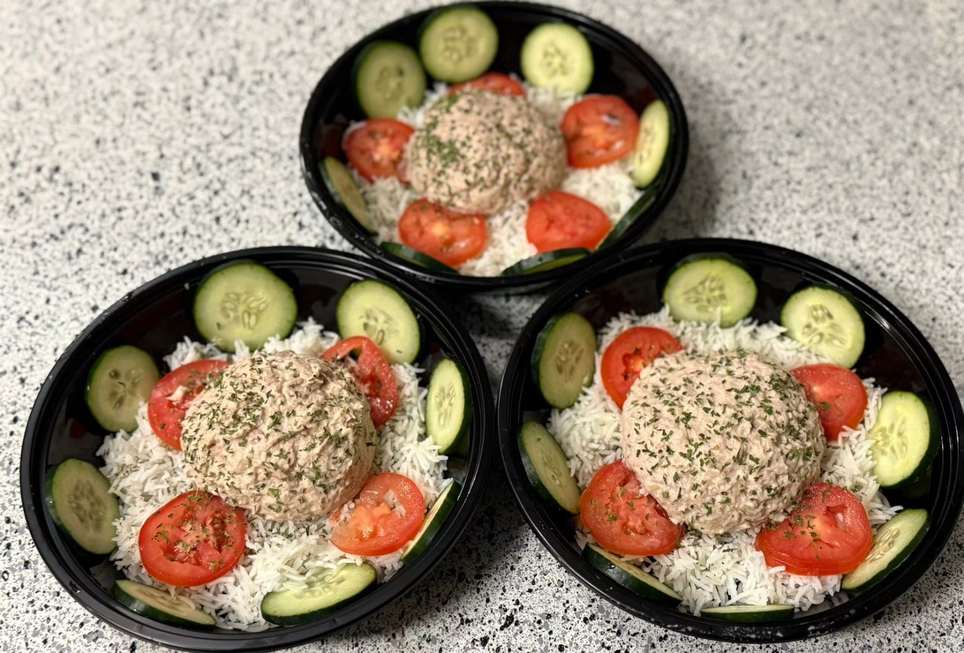 Tuna salad bowls over rice with cucumber and tomato