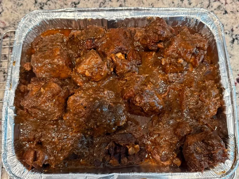 Full pan of smothered oxtails from Pappa Spice Cuisine