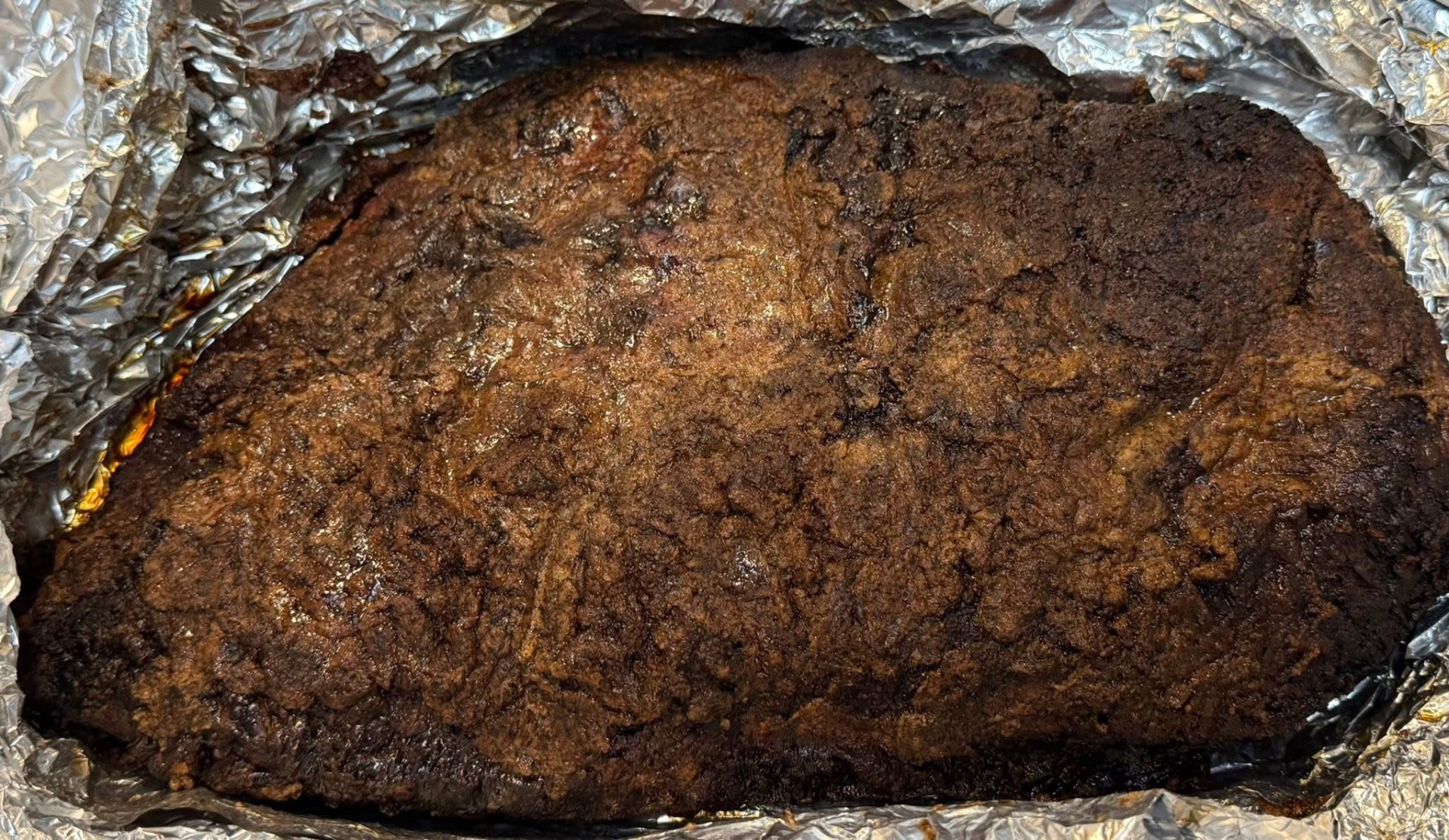 Whole smoked beef brisket prepared for a large Houston celebration