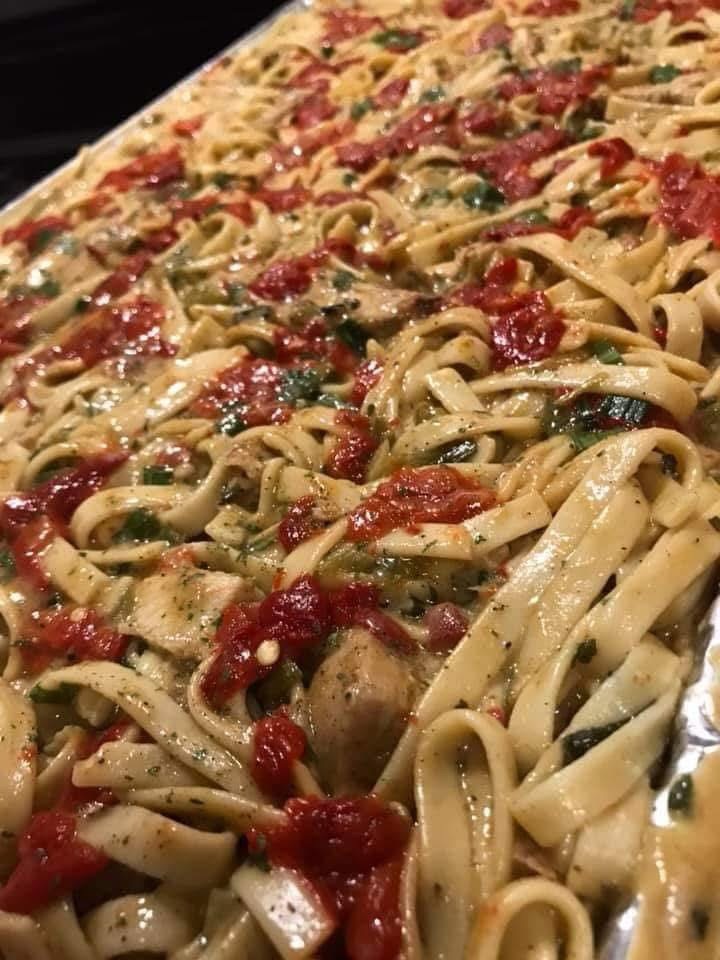 Catering pan of smoked chicken and sausage alfredo pasta