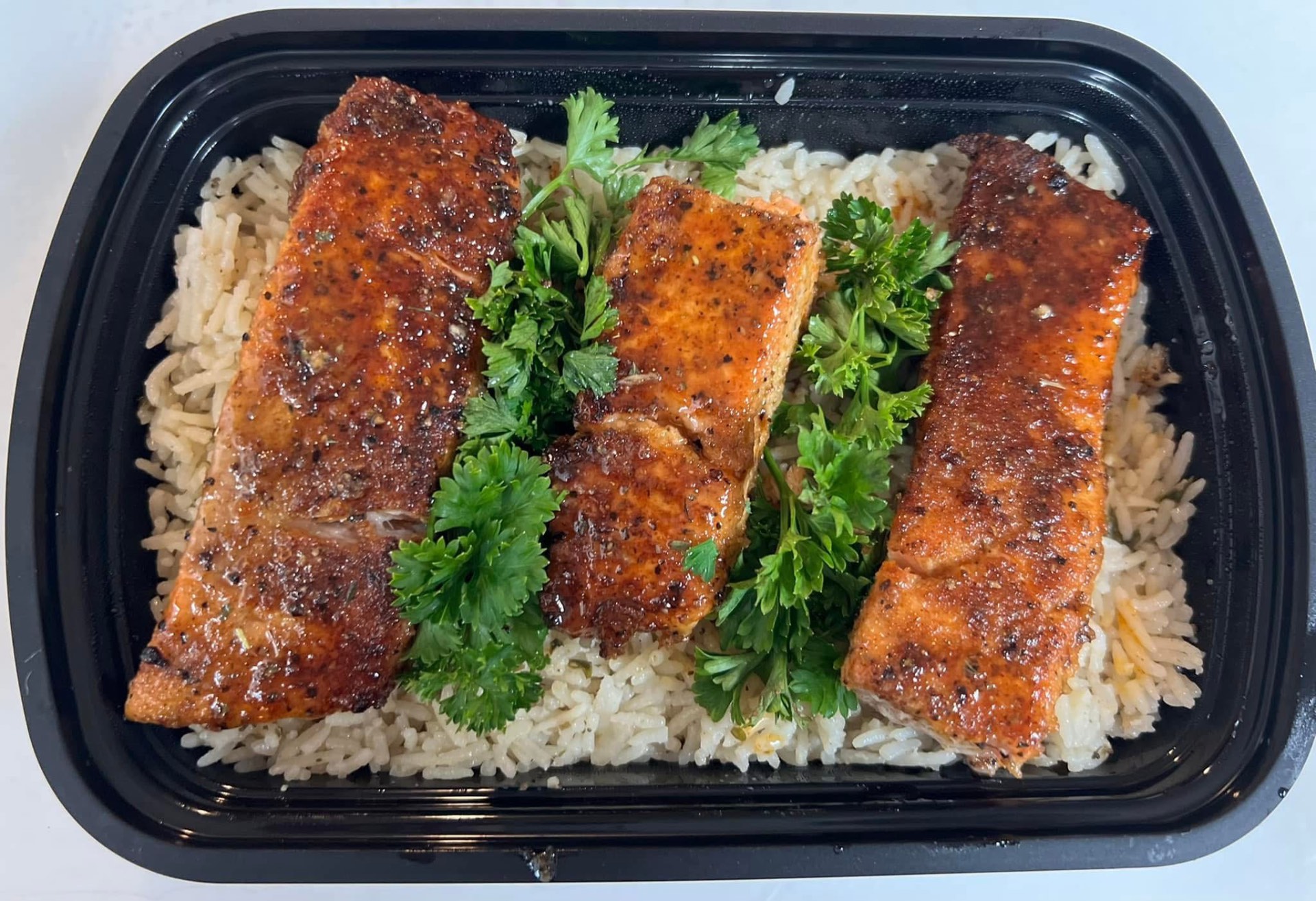 Blackened salmon over rice pilaf catering tray